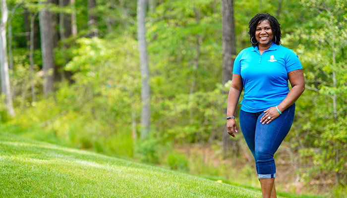 Wounded warrior Taniki Richard standing outside and smiling.