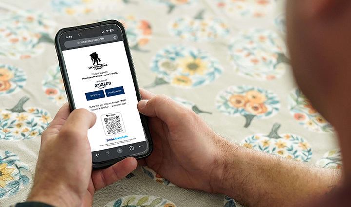 Warrior Mike Larson using his mobile phone to access the SmileAssociate App.