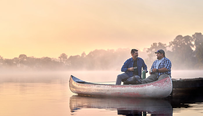 Tim Aponte - veteran and warrior sitting and talking in a canoe.