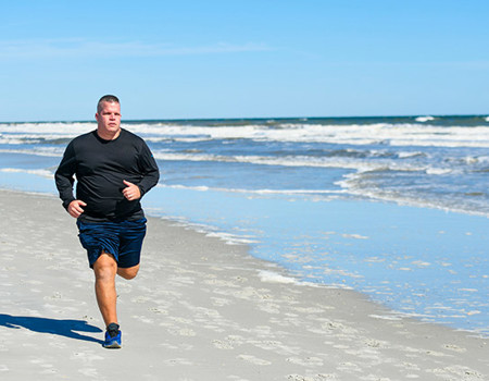 Warrior Josh Wathen running along the beach.