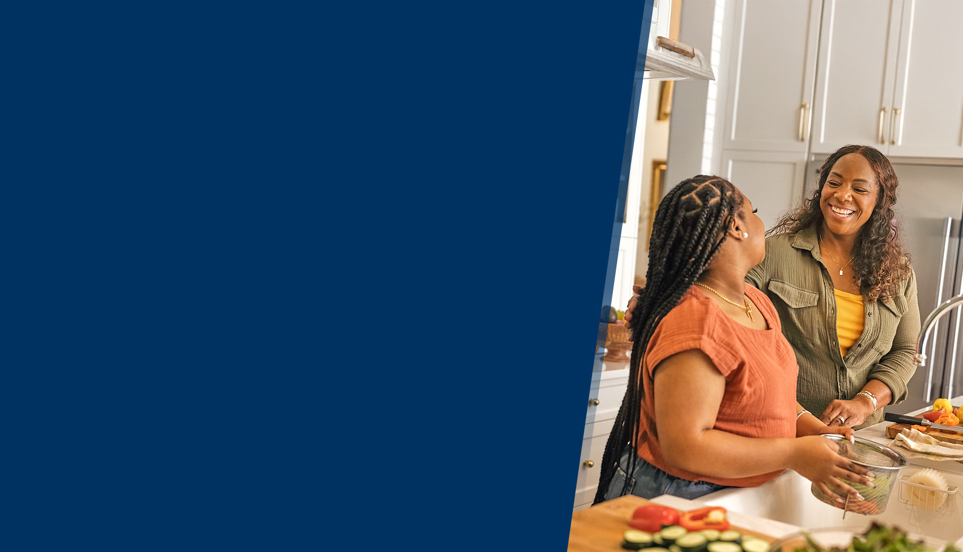 Wounded warrior Yolanda Poullard smiles at her daughter as they prep a meal in her kitchen.