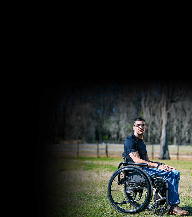 Wounded warrior Mark Lalli in a wheelchair at a horse farm where he helps veterans and disabled people in his community