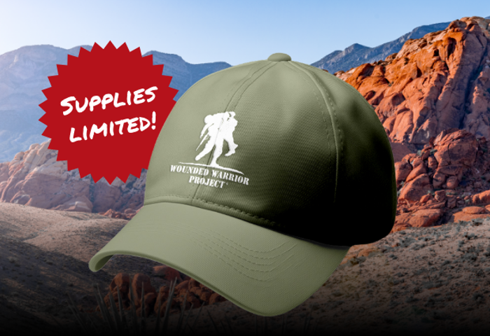 Mountain landscape background with an army green baseball hat with a white WWP logo on the front. Supplies limited graphic next to hat.