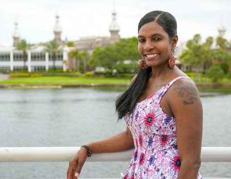 Wounded warrior Tonya Oxendine smiling and posing along a waterfront.