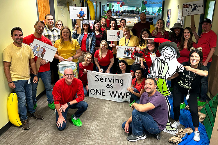 Marketing and Communications teammates take a group picture during the Halloween decoration contest at the Jacksonville office.