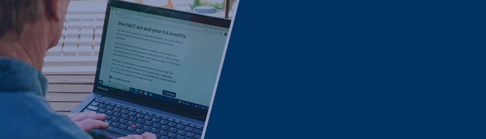 Man reading news article on laptop