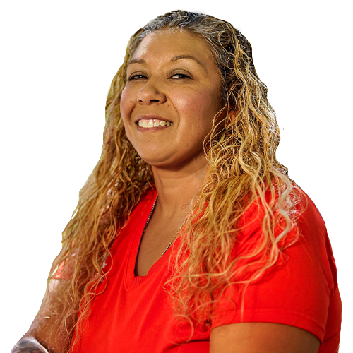 Warrior Ysabel Cardona smiles, wearing a red shirt, while sitting down with her hands joined together.