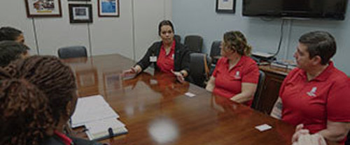 A group of people discussing business in an office conference room
