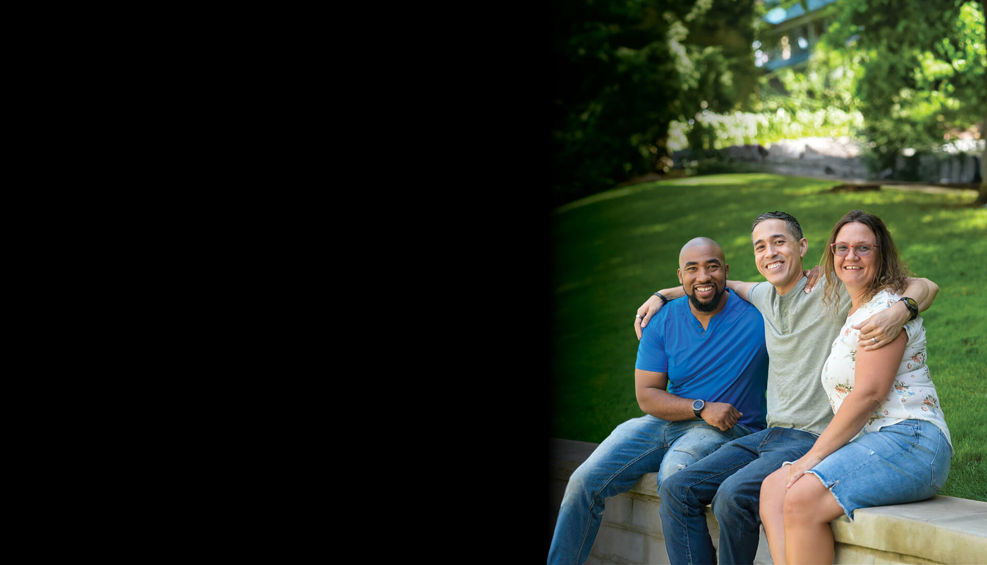 Wounded warrior Sergio Alfaro poses for a photo as he wraps his arms around the shoulders of fellow warriors Michael Powell and Nicole Shorter.